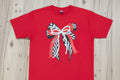 checkered bow with pearl and red bows on top on a red shirt