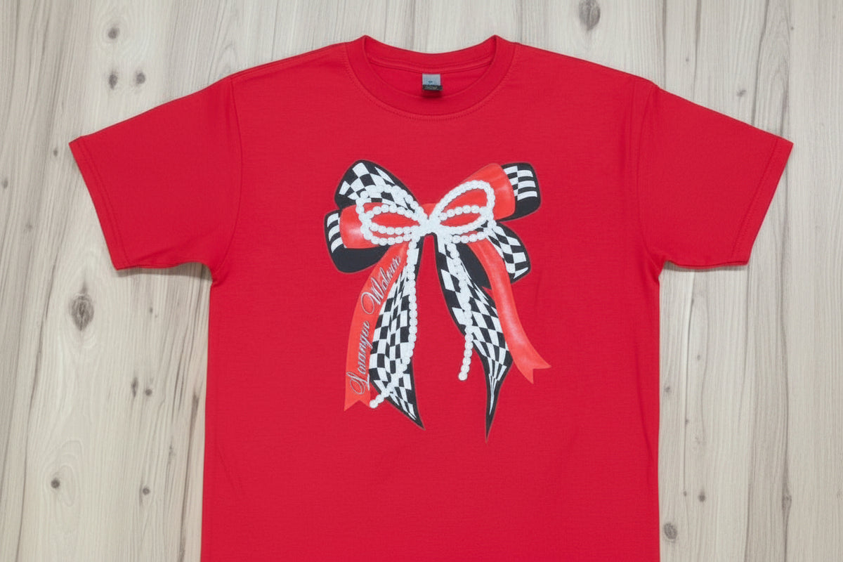 checkered bow with pearl and red bows on top on a red shirt