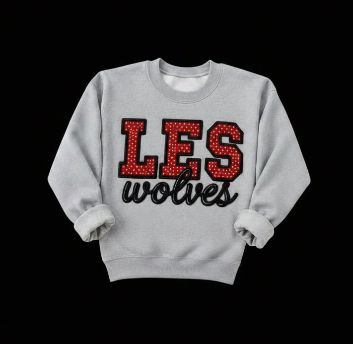 LES red and white polka dot letters with a black outline and embroidered wolves on gray sweatshirt