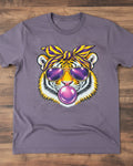 Heather Purple t-shirt on a wooden surface, featuring a graphic print of a tiger wearing yellow and purple sunglasses, a matching headband, and blowing a pink bubblegum bubble.